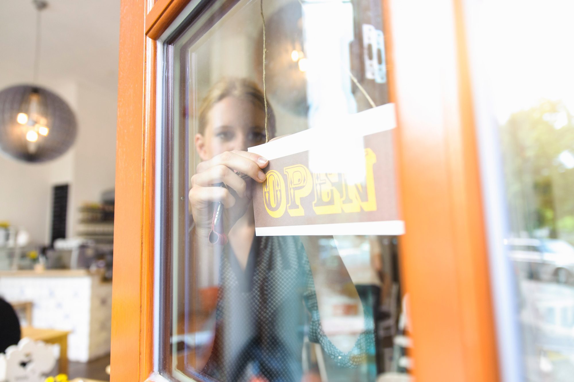 Shopkeeper opening shop for business